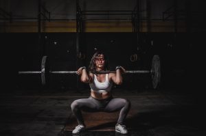 woman lifting heavy weights
